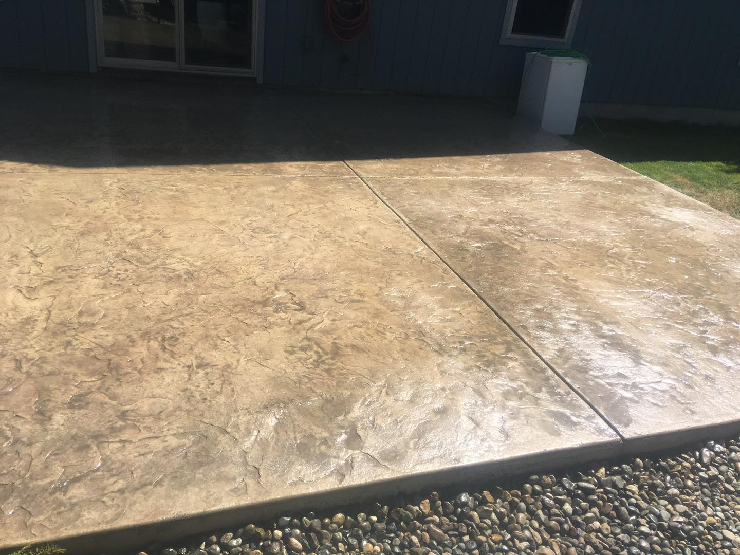 Decorative concrete entry porch with brick stamp pattern