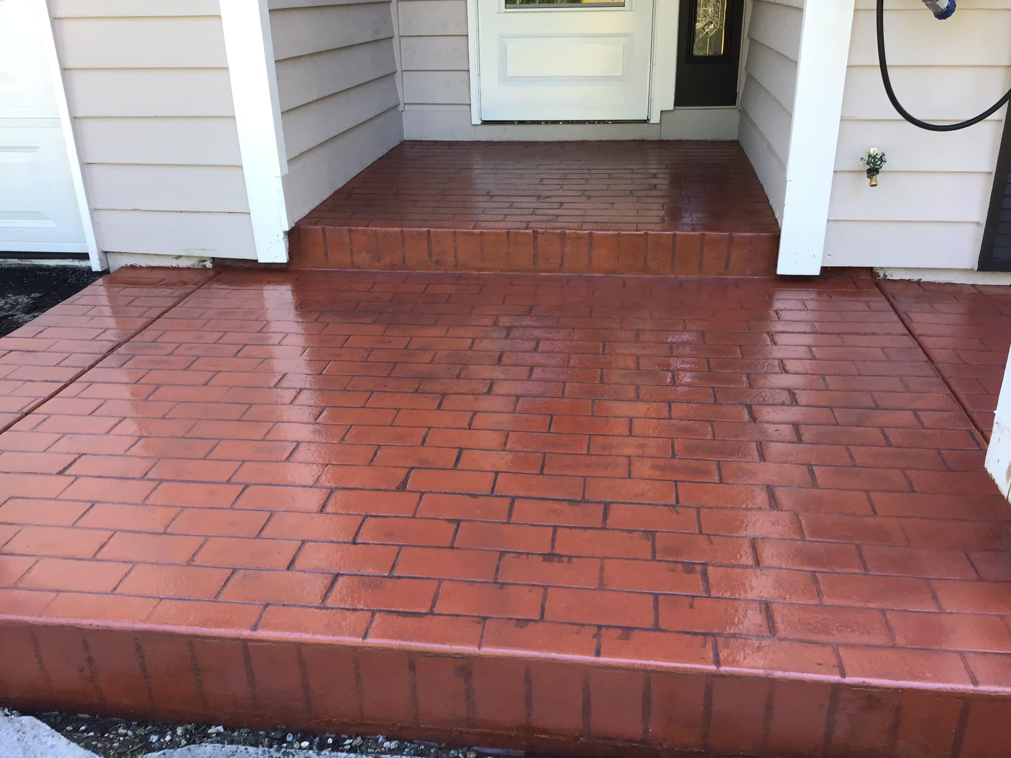 Brick stamp concrete entry porch with color hardener finish